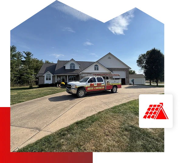 A pickup truck with “roofing & construction” branding is parked in the driveway of a large suburban house with a metal roof in Quincy IL. A person stands by the truck, and a red roof icon for Be Dry Roofing is overlaid in the corner.