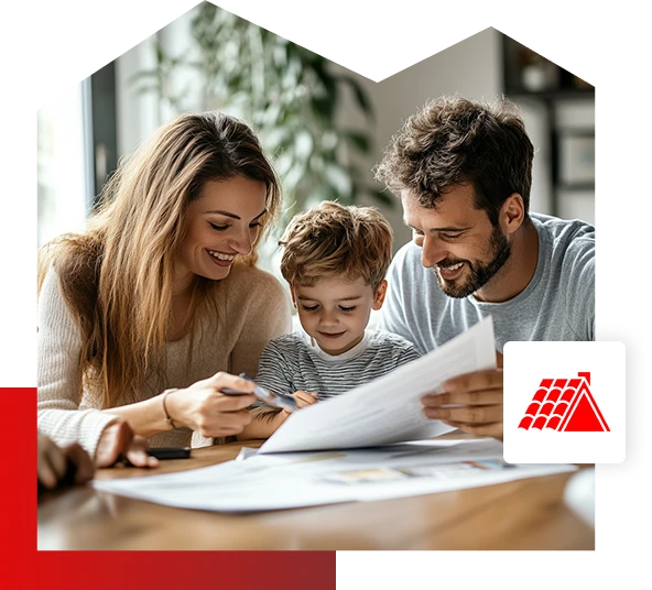 A smiling woman and man sit at a table with a young boy, looking at paperwork together in their bright, cozy Quincy IL home. A red roofing icon for Be Dry Roofing appears in the lower right corner of the image.